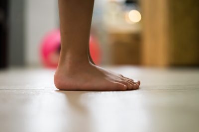 Children's bare feet. Child's bare feet on the wooden floor