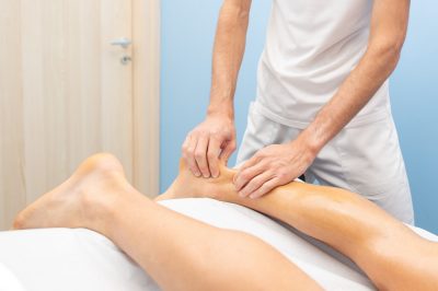 Physiotherapist during an Achilles tendon treatment.